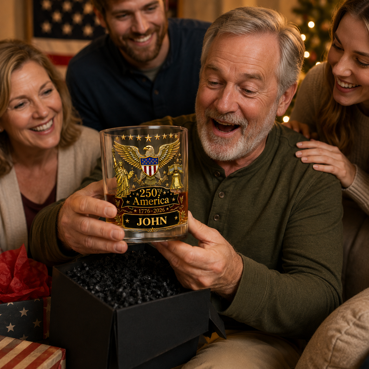 Man receiving a personalized whiskey glass from friends during a celebration.