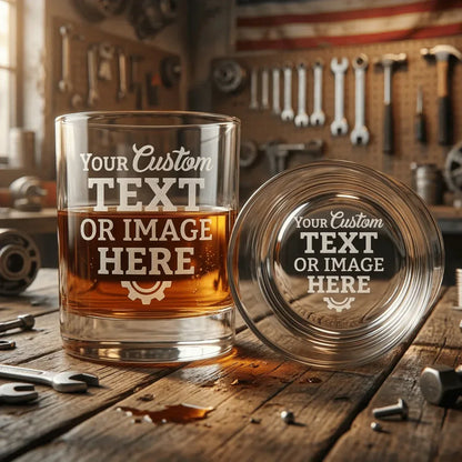 Custom engraved whiskey glass displayed in a workshop setting. Personalized 11oz laser engraved rocks glass gift.