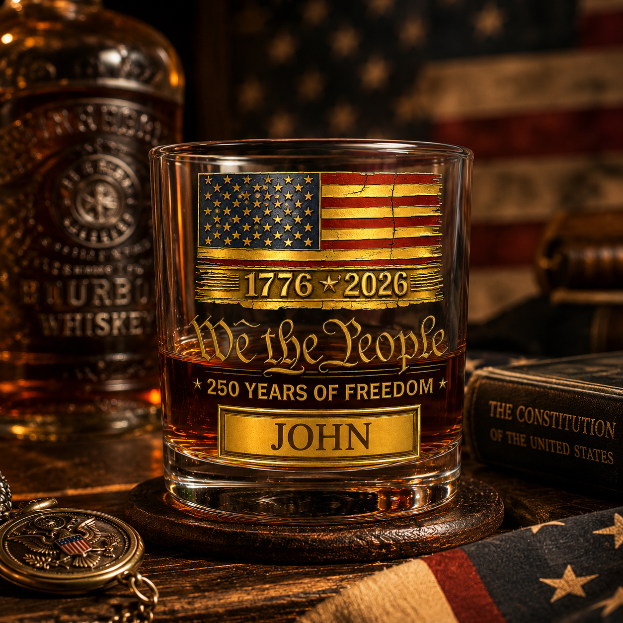 Glass with American flag and text on a wooden surface with a bottle of whiskey and American flag in the background.