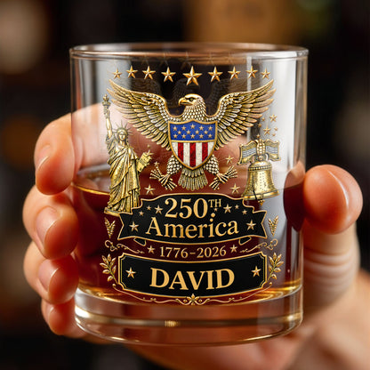 Glass with American-themed design and '250th America' text held by a hand.