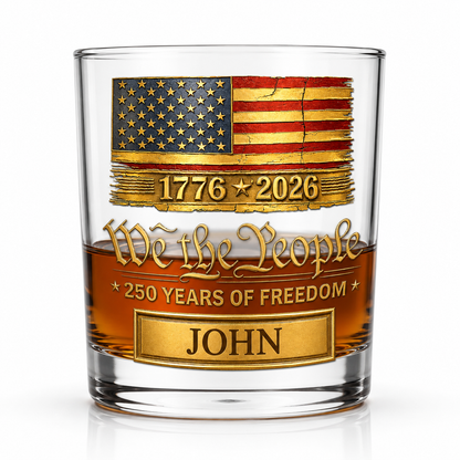 Close-up of a personalized We The People whiskey glass featuring American flag artwork, custom name engraving, and America 250th Anniversary design.
